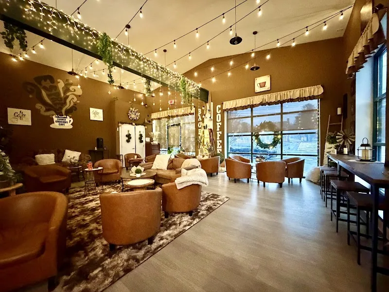 The welcoming Corner Grounds Café lounge with warm pendant lights, cozy chairs and gathering tables