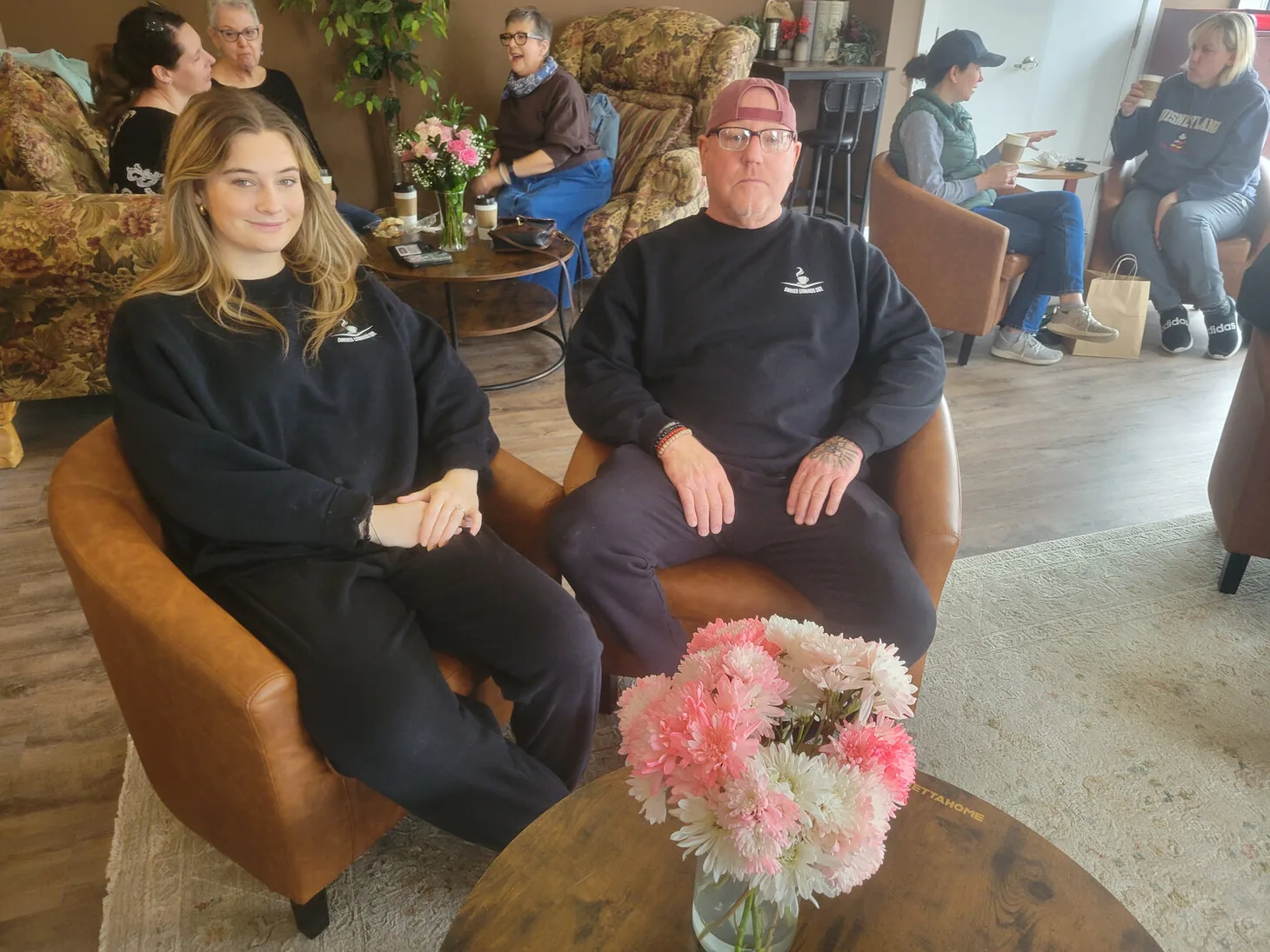 Corner Grounds Café manager Kaylin Reese seated at left with owner Kevin Taisey at right inside the café